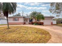 Pink single story home with a large front yard and circular driveway at 3530 25Th N Ave, St Petersburg, FL 33713