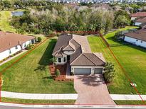 Single-story home with tile roof, large backyard, and two-car garage at 5287 Rushmere Ct, Palmetto, FL 34221