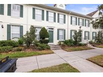 Front view of charming townhouses with green shutters and landscaping at 9911 New Parke Rd, Tampa, FL 33626