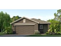 One story home with brown siding, two car garage, and landscaping at 10256 Kalamazoo Pl, Parrish, FL 34219