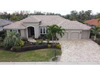 Luxury home with tile roof and three-car garage at 10626 Restoration Ter, Bradenton, FL 34212
