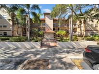 Spanish style condo building, lush landscaping, inviting entrance at 2400 Feather Sound Dr # 1215, Clearwater, FL 33762