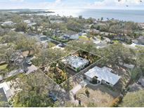 Aerial view of a single-Gathering home with a waterfront lot at 3613 S Gardenia Ave, Tampa, FL 33629