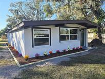 Newly renovated home with a modern exterior and colorful landscaping at 503 Water St, Plant City, FL 33563