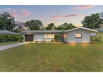 Charming ranch home with a well-manicured lawn and updated facade at 936 Lyndhurst St, Dunedin, FL 34698