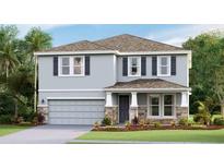 Two-story house with gray siding, stone accents, and a two-car garage at 10810 Patoka Ter, Parrish, FL 34219