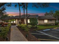 Well-maintained community building with landscaping and parking at 13215 Slash Pine Dr # H, Hudson, FL 34669