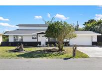 Updated two-story home with modern exterior and landscaping at 177 Dowling Ne Ave, Port Charlotte, FL 33952