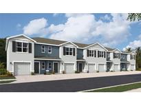 Modern townhome development with attached garages and neutral color palette at 2758 Pearly Banks Dr, Bradenton, FL 34208