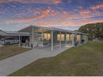 Single-wide manufactured home with carport and landscaped yard at 35921 Hermoso Ln, Zephyrhills, FL 33541