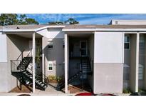 Exterior view of a condo building with stairs and landscaping at 4507 S Oak Dr # P71, Tampa, FL 33611