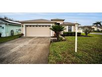 Single-story home with attached garage and well-manicured lawn at 1215 Dustan Pl, Trinity, FL 34655