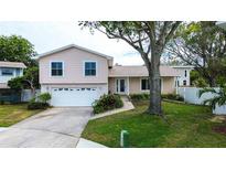 Two-story house with attached garage and landscaped lawn at 12430 81St Pl, Seminole, FL 33772