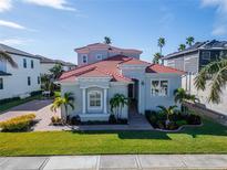 Two-story house with a red tile roof, white columns, and lush landscaping at 1308 Alhambra Dr, Apollo Beach, FL 33572