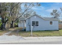 Gray house with a detached garage, and a small front yard at 1575 S Martin Luther King Jr Ave, Clearwater, FL 33756