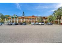 Front view of a two-story building with several units and ample parking at 2292 Austrian Ln # 22, Clearwater, FL 33763