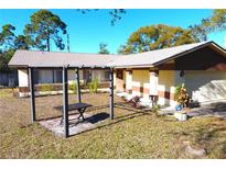Ranch style home with carport and nicely landscaped yard at 7809 Dover N Ct, St Petersburg, FL 33709
