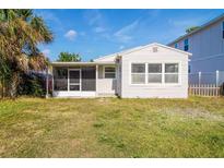 Cute bungalow style home with a screened porch and grassy yard at 783 48Th N Ave, St Petersburg, FL 33703