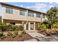 Tan two-story townhome with landscaped grounds and gated entry at 835 7Th N Ave, St Petersburg, FL 33701