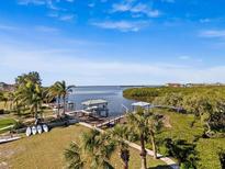 Stunning aerial view of waterfront property with private dock and boat lift at 1614 Sea Breeze Dr, Tarpon Springs, FL 34689
