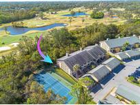 Aerial view of condo community, tennis court, golf course, and pool nearby at 3157 Landmark Dr # 411, Clearwater, FL 33761