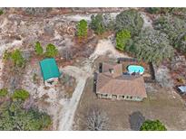 Aerial view of house, pool, and shed at 12404 Dolquieb Ln, Weeki Wachee, FL 34614