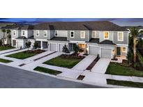 New townhome community with attached garages and lush landscaping at 2123 Hallier Cv, Wesley Chapel, FL 33543