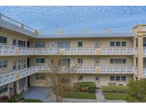 Two-story building with balconies and landscaping at 2286 Mexican Way # 52, Clearwater, FL 33763