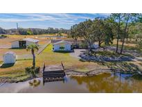 Aerial view of a home on acreage with a pond, barn, and private dock at 3050 Maple Trce, Tarpon Springs, FL 34688