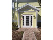 Inviting building entrance with a white door and brick pathway at 5215 Coquina Key Se Dr # A, St Petersburg, FL 33705