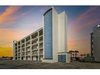 Exterior view of a light blue and white building with balconies at 9825 Harrell Ave # 202, Treasure Island, FL 33706