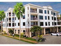 Three-story building with multiple balconies and ample parking at 231 2Nd S St # 203, Safety Harbor, FL 34695