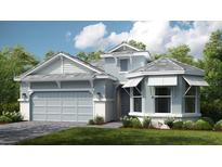 Two-story home with light blue siding, gray roof, and a two-car garage at 5531 Orsello St, Palmetto, FL 34221