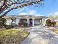 White single story home with carport and mature landscaping at 1009 Harefield Cir # 47, Sun City Center, FL 33573