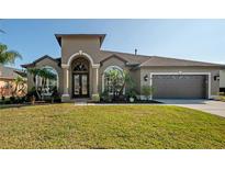 Beautiful one-story home with a two-car garage and manicured lawn at 10126 Londonshire Ln, Tampa, FL 33647