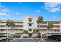 Attractive condo building with ample parking and lush landscaping at 1524 Lakeview Rd # 305, Clearwater, FL 33756