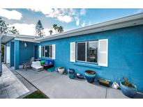 Side view of a charming blue house with white shutters and a partially visible front yard at 17744 1St E St, Redington Shores, FL 33708