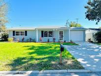 Newly renovated single-story home with a landscaped lawn and driveway at 3528 Linkwood St, New Port Richey, FL 34652