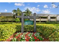 Building exterior showcasing landscaping and signage for Muirfield Lodge 15 at 36750 Us Highway 19 N # 15118, Palm Harbor, FL 34684