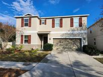 Two-story house with a two-car garage and landscaped lawn at 1102 Lake Highview Ln, Brandon, FL 33510