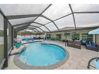 Inviting pool area with covered patio and comfortable seating at 13527 Willow Bluestar Loop, Riverview, FL 33579