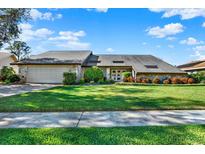 Beautiful home with stone accents, large yard, and a paved driveway at 14216 Banbury Way, Tampa, FL 33624