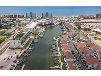 Aerial view of waterfront community with marina, pool, and recreational areas at 320 Medallion Blvd # D, Madeira Beach, FL 33708