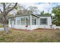 Newly renovated home with a sunroom and a landscaped front yard at 6699 78Th N Ave, Pinellas Park, FL 33781