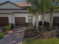 Two-car garage and light gray front door at 10374 Echo Dock Loop, San Antonio, FL 33576