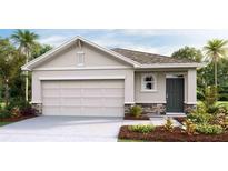 One-story home with a two-car garage, stone accents, and landscaping at 10551 Dusty Boot Rd, Land O Lakes, FL 34638