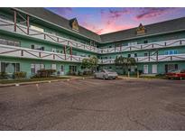 Two-story building with parking lot, showcasing a tranquil evening scene at 2043 Denmark St # 65, Clearwater, FL 33763