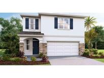 Two-story house with a two-car garage, stone accents, and landscaping at 33182 Osprey Peak Way, San Antonio, FL 33576