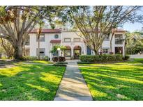 Updated condo building with manicured lawn and walkway at 492 Santa Cruz Ne Pl # D, St Petersburg, FL 33703