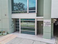 Modern building exterior with glass and green accents. 111 N. 12th St. entrance at 111 N 12Th St # 1812, Tampa, FL 33602